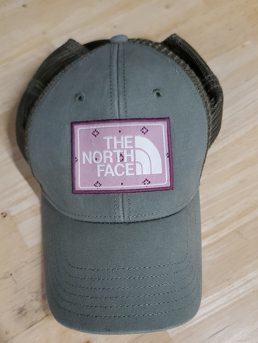 The North Face Olive Green Trucker Hat with Pink Logo Patch